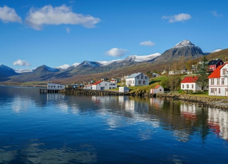 The waterside village of Fáskrúðsfjörður with mountains behind
