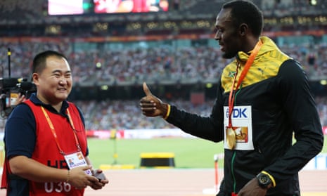 Usain Bolt with Song Tao, the cameraman who knocked him over moments after winning the 200m world title in Beijing.