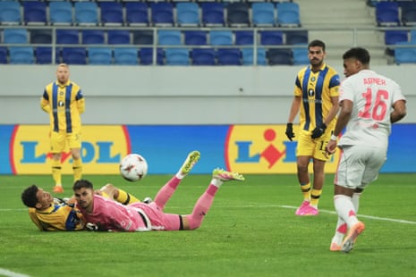 Lyon's Abner (right) pops the ball into an empty net to open the scoring against Maccabi Tel Aviv.