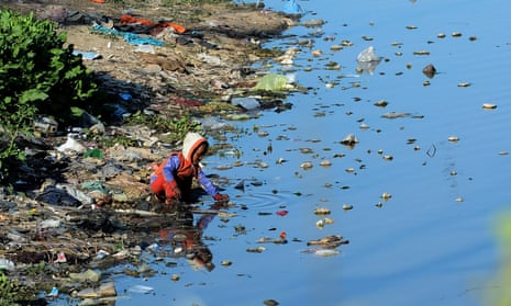 A boy plays in the waters of a polluted canal in Lahore