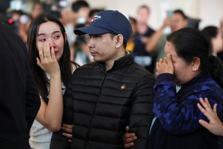 Relatives of Sathian Suwannakham greet him as he arrives at Bangkok Suvarnabhumi airport on Sunday.