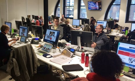 Guardian Australia journalists in the Sydney office react as the leap second passes by on July 1, 2015. News editor Mike Ticher (middle right) is pictured showing Alan Evans that his online clock has stopped working three seconds short of the event.