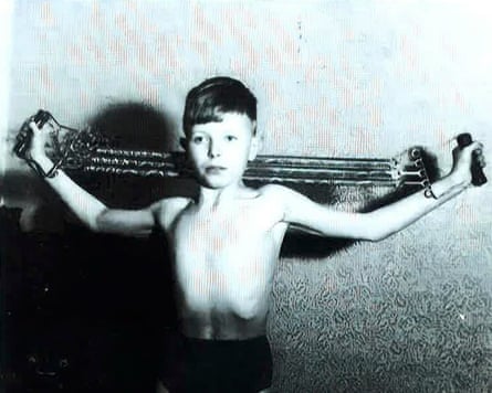 The young Bowie using a strength device at home.