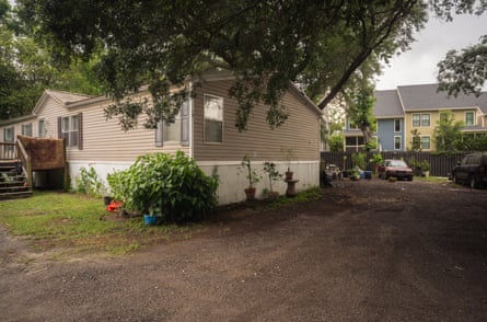 A gray fence separates the village from Ford’s family compound, a stark dividing line between the new wealthy residents and the former inhabitants who reside in about 10 mobile homes.