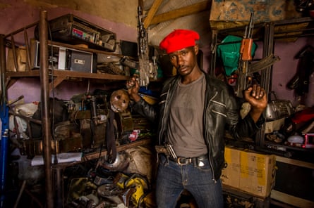 Wakaliwood actor Ronald Kazibwe, alias Sergi, chooses the guns from a weapons workshop he will use in the next scene of a film.