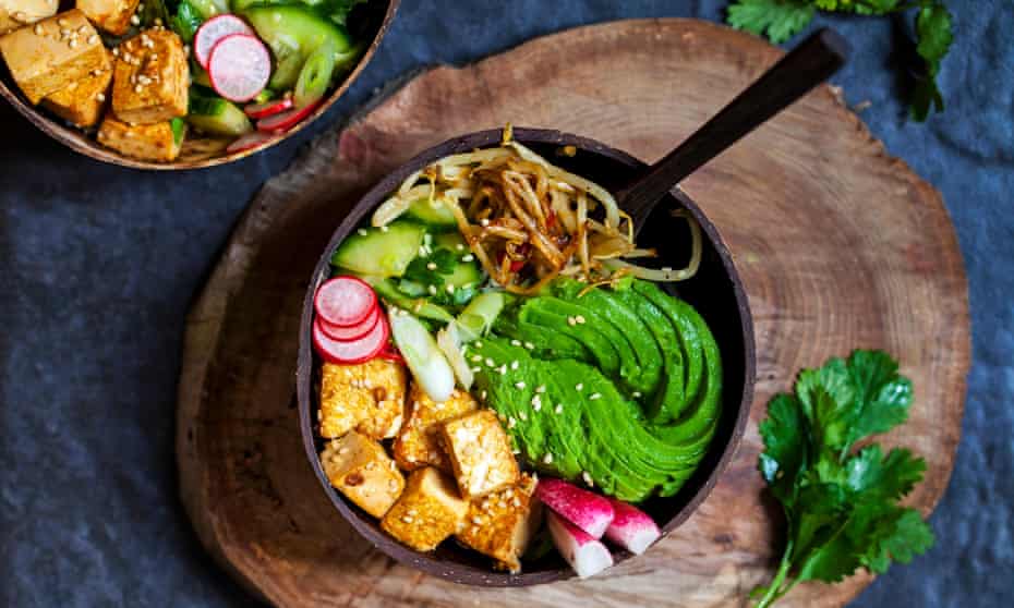 Vegan bowl with avocado, silky tofu, bean sprouts and pickled vegetables over rice