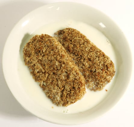 Weetabix breakfast cereal. Two pieces in a bowl with the milk poured on.