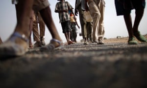 Ethiopian immigrants walk on the side of a highway to the western Yemeni town of Haradh on the border with Saudi Arabia.