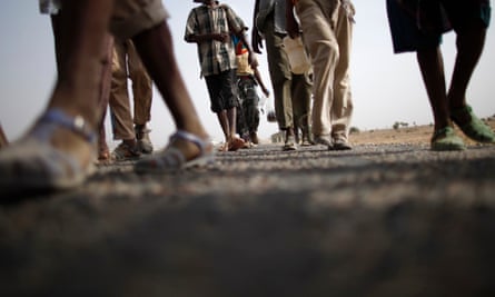 Ethiopian immigrants walk on the side of a highway to the western Yemeni town of Haradh on the border with Saudi Arabia.