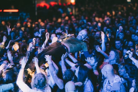 Mikey Young crowdsurfing at a packed out free gig at Federation Square in Melbourne.