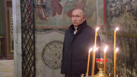 Putin attends Orthodox Christmas service alone – video