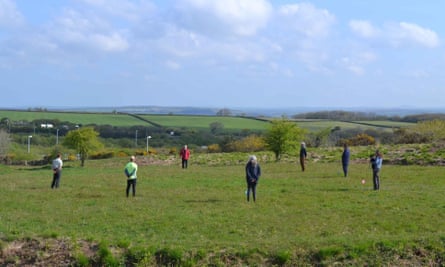 Volunteers stand on the seven pits found at Castilly Henge near Bodmin.