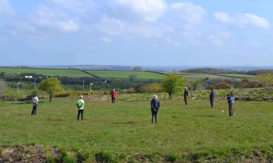 Volunteers stand on the seven pits found at Castilly Henge near Bodmin.