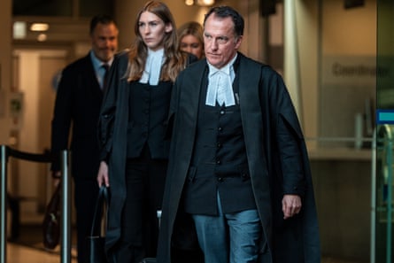 Dressed in robes, Colin Mandy SC, leaves the courthouse