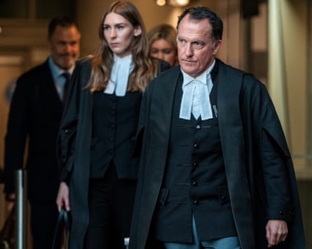 Colin Mandy wearing barrister’s robes walking out of a building