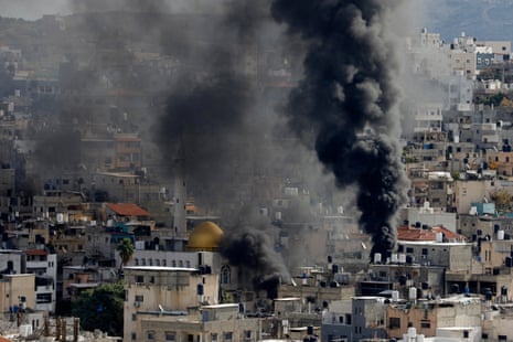 Smoke rises above buildings in the Nour al-Shams refugee camp near the occupied West Bank city of Tulkarem, during an ongoing israeli raid on 4 January.