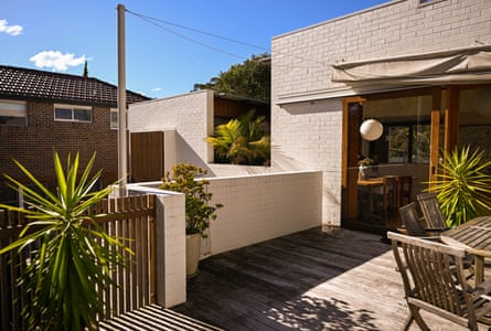 The two homes are divided by doors and internal courtyards that capture the breeze and north light when the families want privacy.