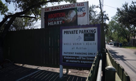 An anti-abortion billboard next to the sign for the only abortion clinic in Texas’s Rio Grande valley