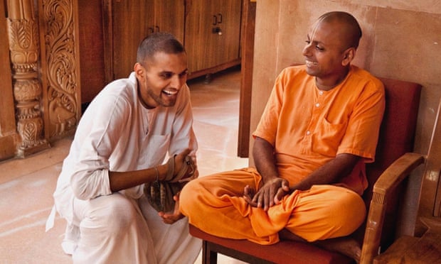 Jay Shetty as a monk in a white robe, talking to a saffron-robed monk