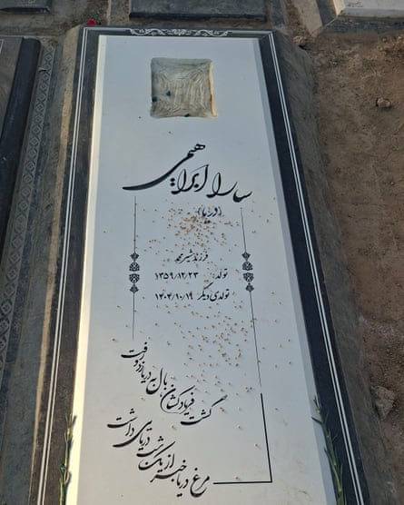 An Iranian gravestone for a woman called Sara, in white stone with black Persian script.