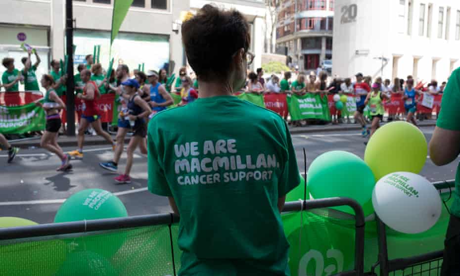 Charity supporters from Macmillan Cancer Support encourage participants taking part in the London Marathon in April 2018.