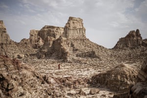 A man walks through a salt canyon