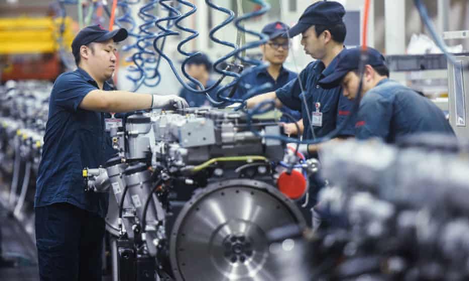 Workers produce heavy truck engines at a factory in Hangzhou, in China's eastern Zhejiang province. 