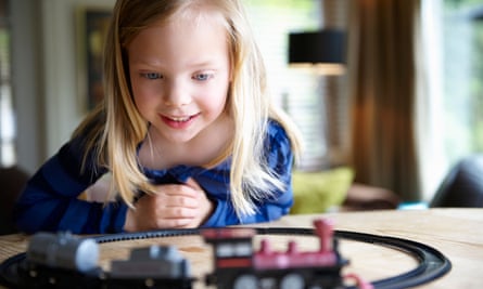 A girl playing with a toy train