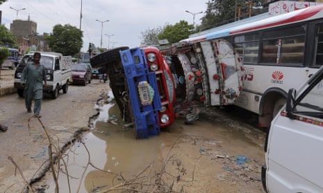 A truck lying overturned on a flood-damaged road in Karachi on Friday.