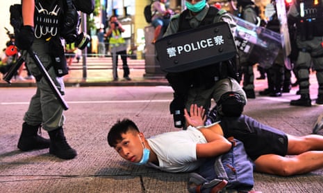 Police officers detain a protesters during a rally against a new national security law on the 23rd anniversary of the handover of Hong Kong from the UK to China