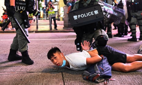 Police holding a pro-democracy protester in Hong Kong last week.