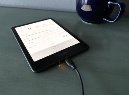 an e reader plugged in and charging on a table