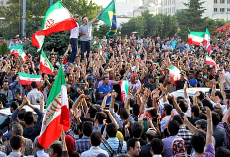 Iranians celebrate at Vanak Square in northern Tehran after Iran sealed qualification for the 2014 World Cup.