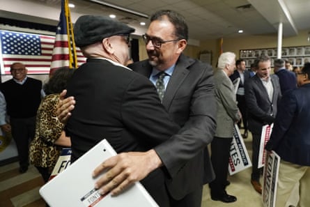 Adrian Fontes, right, gets a hug from Chuck Coughlin after Fontes declared victory in his race on Monday.