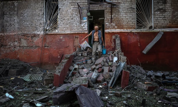 A man leaves his damaged apartment building following a missile strike in Kramatorsk, Donetsk region, Ukraine, on 31 August.