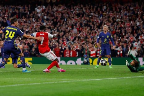 Bukayo Saka of Arsenal fires home to open the scoring.