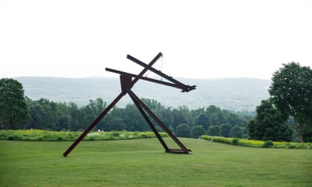 an arrangement of dark-colored I-beams on the grass