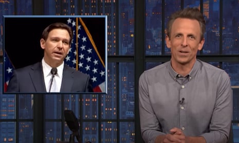 Seth Meyers with a picture of Ron DeSantis