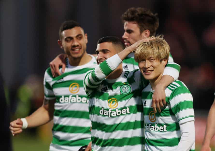 Celtic's Kyogo Furuhashi and Liel Abada celebrate with their teammates after winning the Scottish Premiership title.