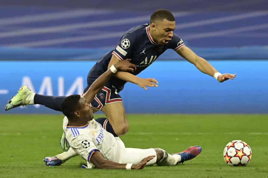 PSG’s Kylian Mbappe falls as he is tackled by Real Madrid’s David Alaba.