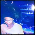 A black woman looks down with writing in the corner denoting an album cover