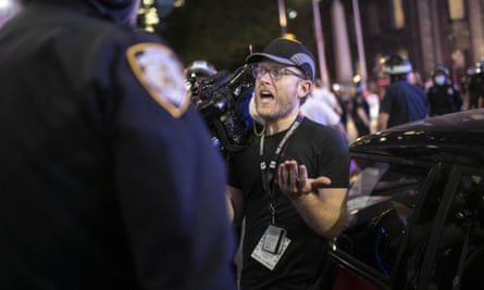 AP journalist Robert Bumsted reminds a police officer that the press are considered ‘essential workers’. NYPD officers surrounded, shoved and yelled expletives at him and his co-worker.