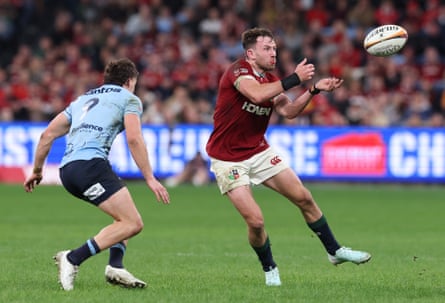 Hugo Keenan passes the ball while playing for the Lions.