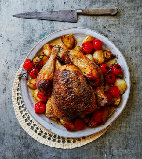 Thomasina Miers’ chicken stuffed with lemony black olives, garlic and oregano with crisp potatoes and roast tomatoes.