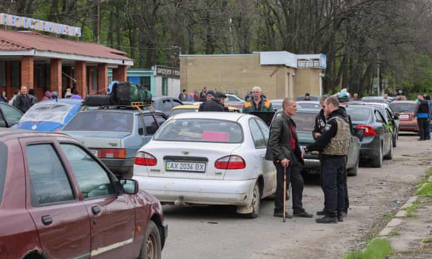 Residents wait to be evacuated from the village of Ruska Lozova, near Kharkiv.