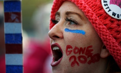 Kelly Duncan chants with “Gone 2020” slogan painted on her cheek as she participates in the Second Annual Women’s March in Washington, U.S., January 20, 2018. REUTERS/Leah Millis