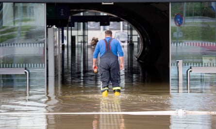 A firefighter wades through floodwater at a train station in Pixendorf, Lower Austria, on Tuesday.