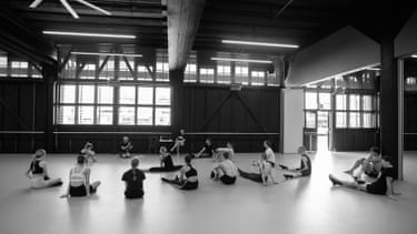 A black and white photograph shows the cast of Impermanence seated on the floor of a practice studio, 2012