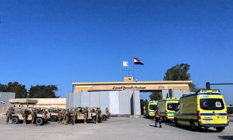 Ambulances queue to cross the Rafah border from the Egyptian side to transport the injured from Gaza