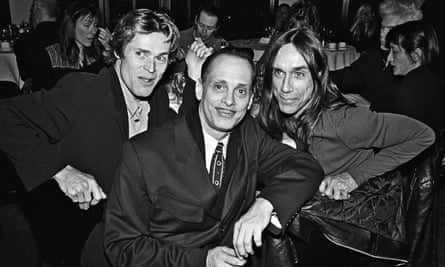 Black and white photo of Willem Dafoe with John Waters and Iggy Pop in 1994, all wearing suits.